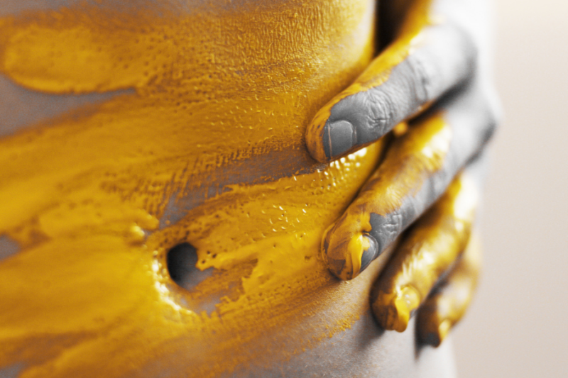 close up of stomach with yellow paint