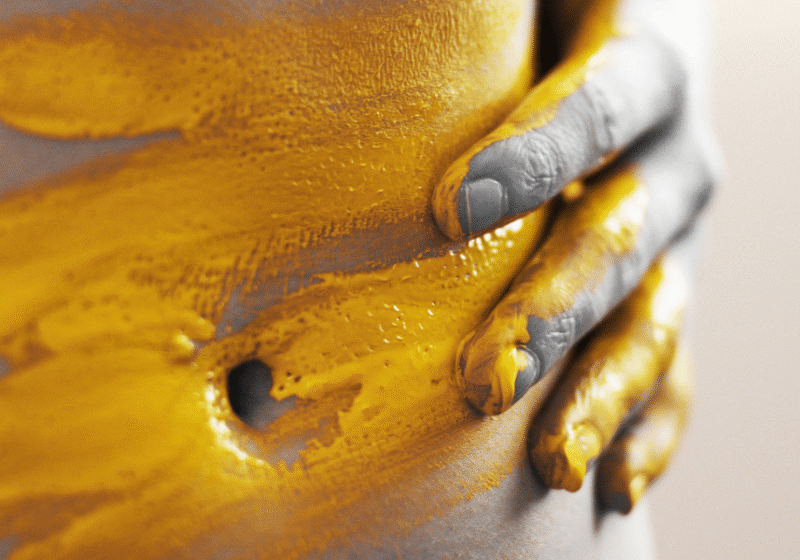 close up of stomach with yellow paint