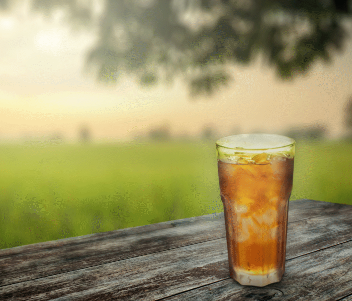 glass of ice tea on picnic table outdoors