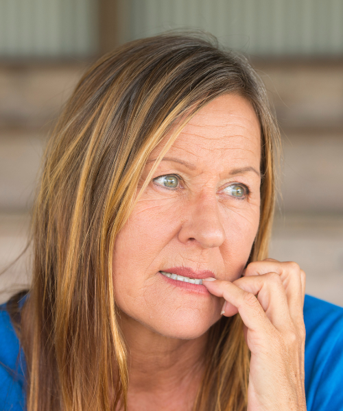 woman biting nails appearing checked out