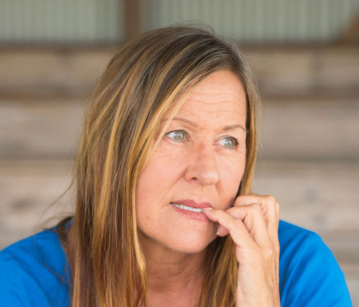 woman biting nails appearing checked out