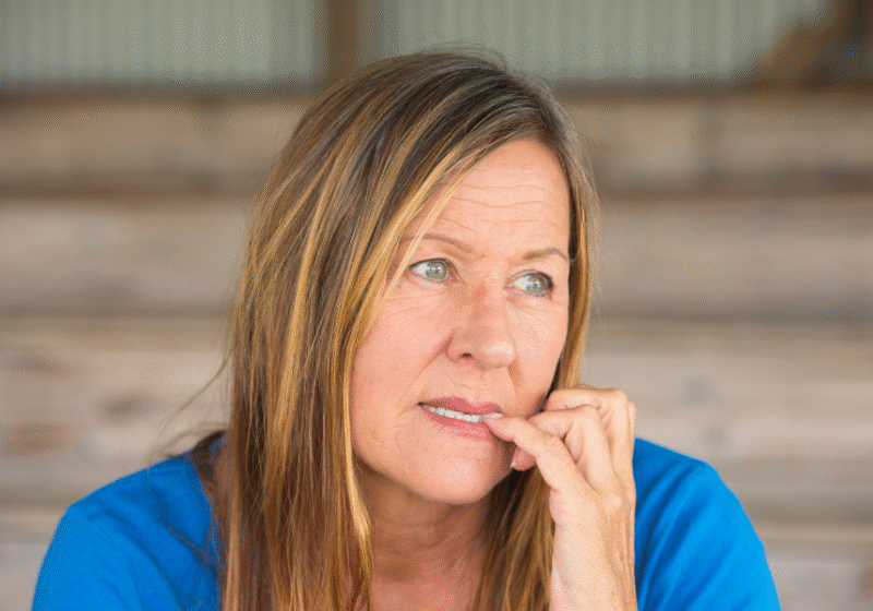 woman biting nails appearing checked out